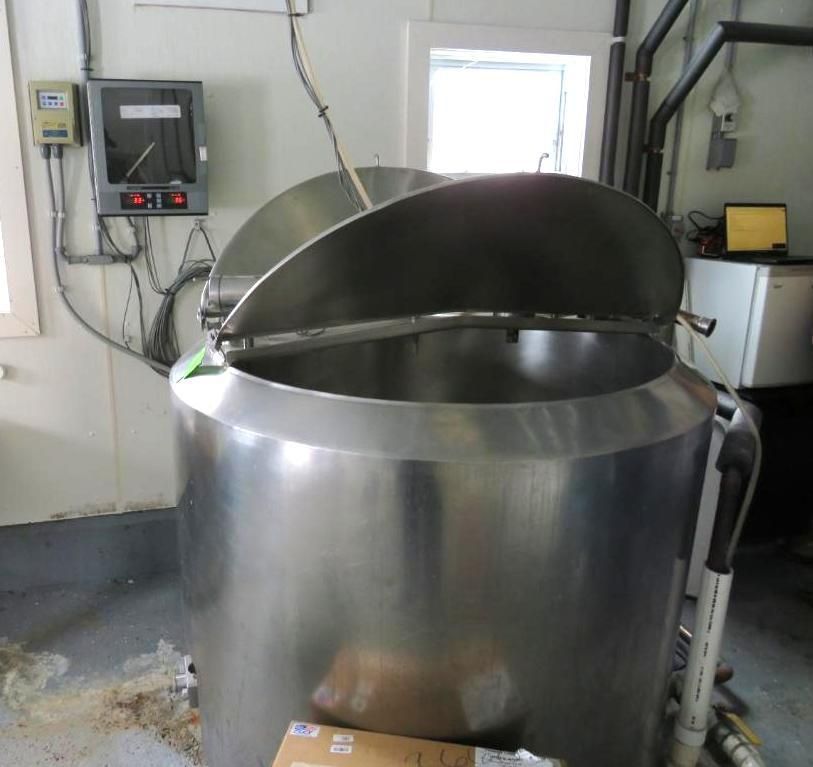 Large, stainless steel vat with open lid.