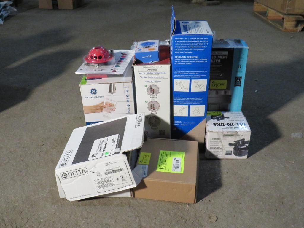 Pile of cardboard boxes on a concrete surface, containing various products, with labels visible.