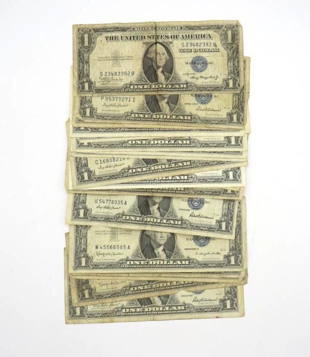 Stack of old one-dollar bills, featuring George Washington, on a white background.