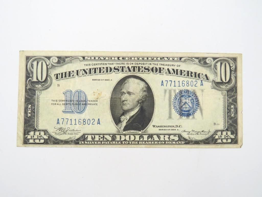 Ten-dollar U.S. bill featuring a portrait of Alexander Hamilton and blue seals.