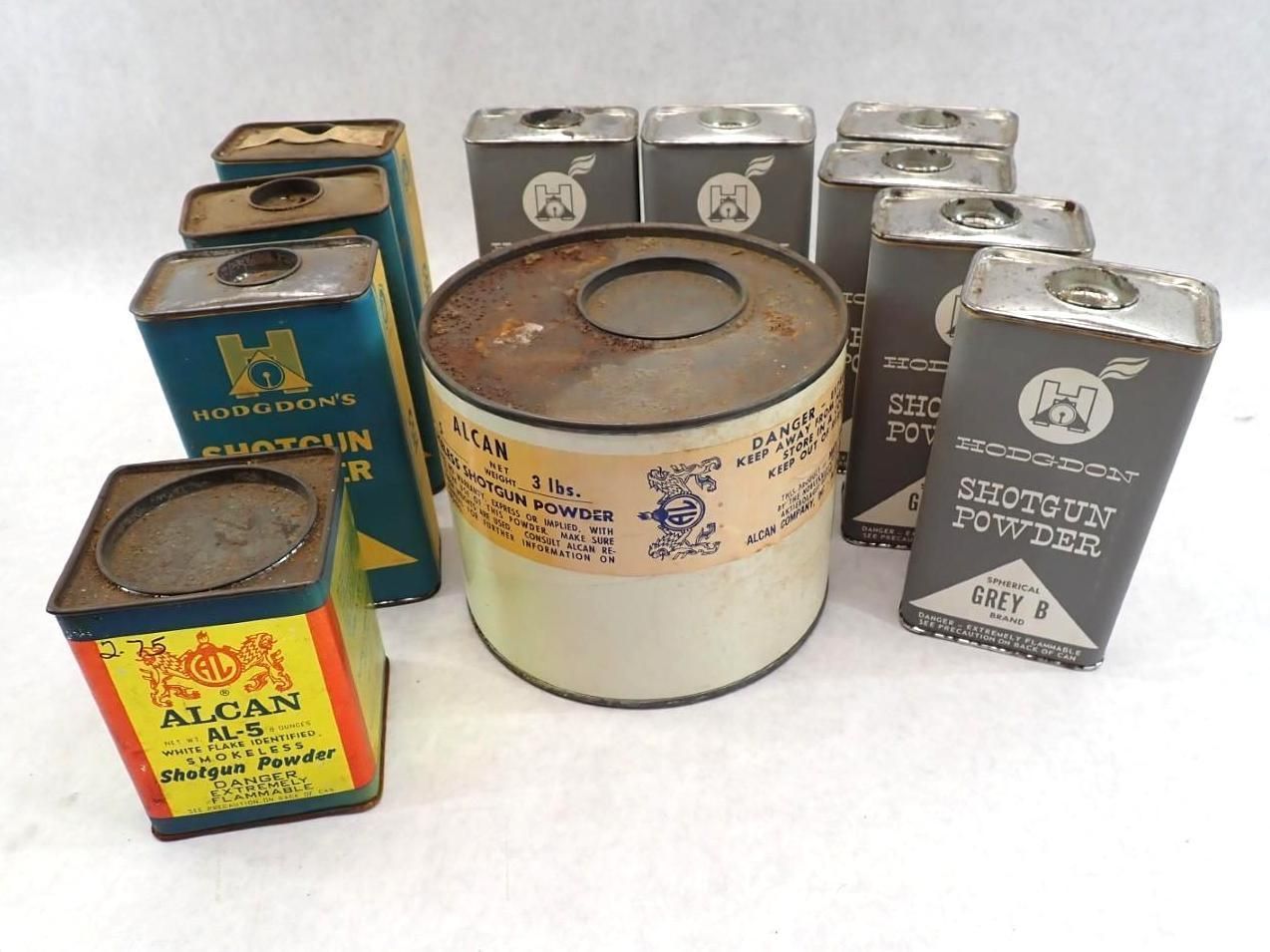 Assorted vintage metal cans and containers arranged on a white background