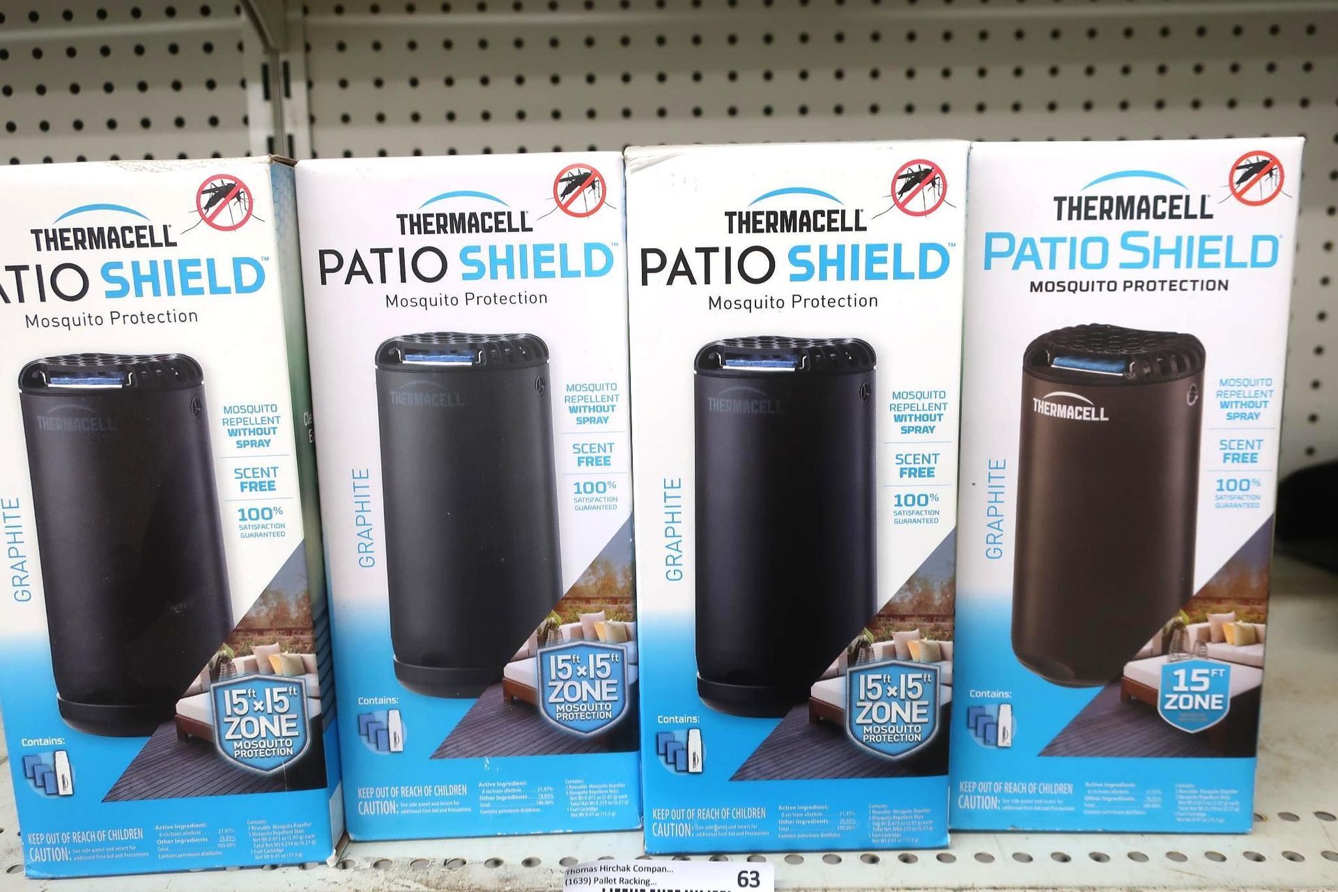 Four Thermacell Patio Shield mosquito repellent boxes on a shelf, dark with blue accents.