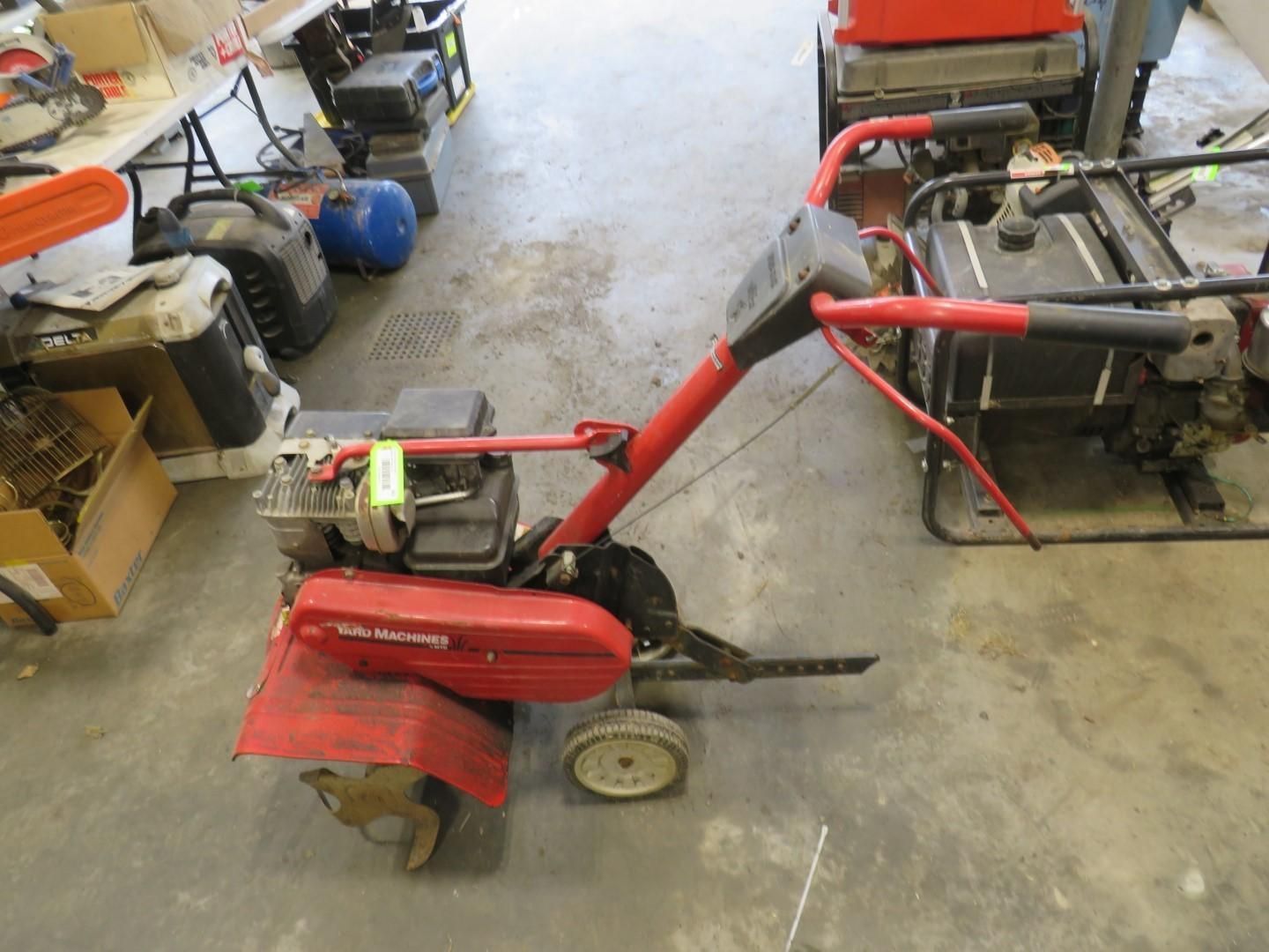 Red Craftsman rototiller on a concrete floor.
