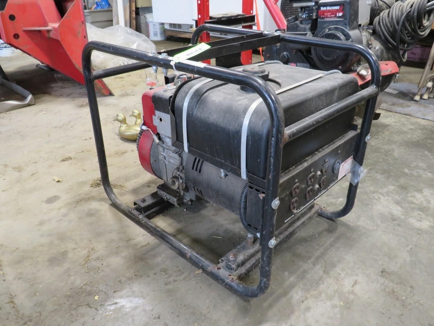 Generator with black and red frame, in a workshop setting.