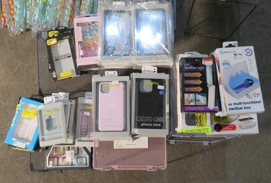 Assortment of phone cases and accessories displayed on a table for sale.