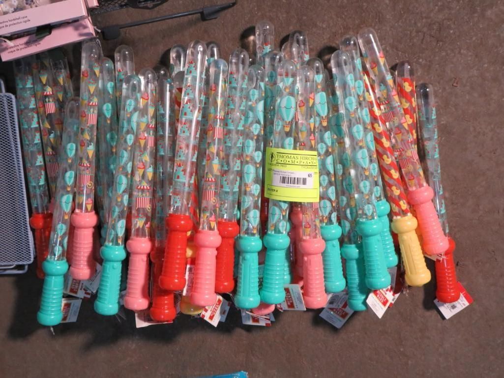 Stack of colorful bubble wands with pink, teal, and red handles.