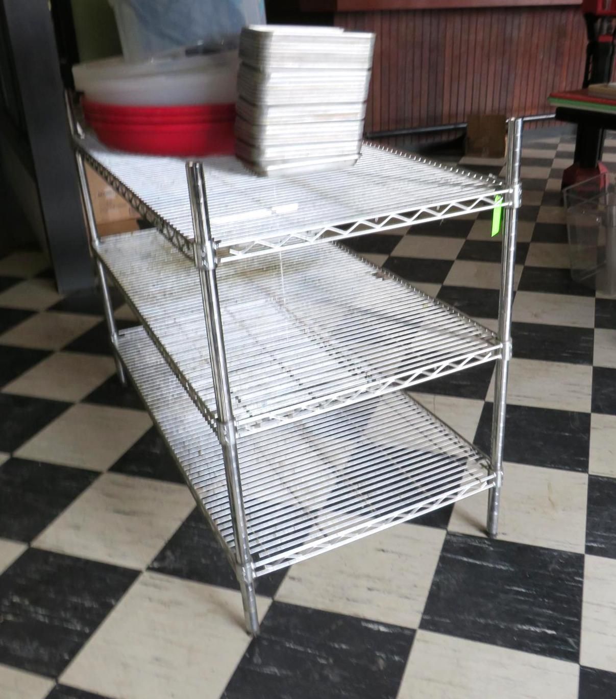 Metal wire shelving unit with three levels.
