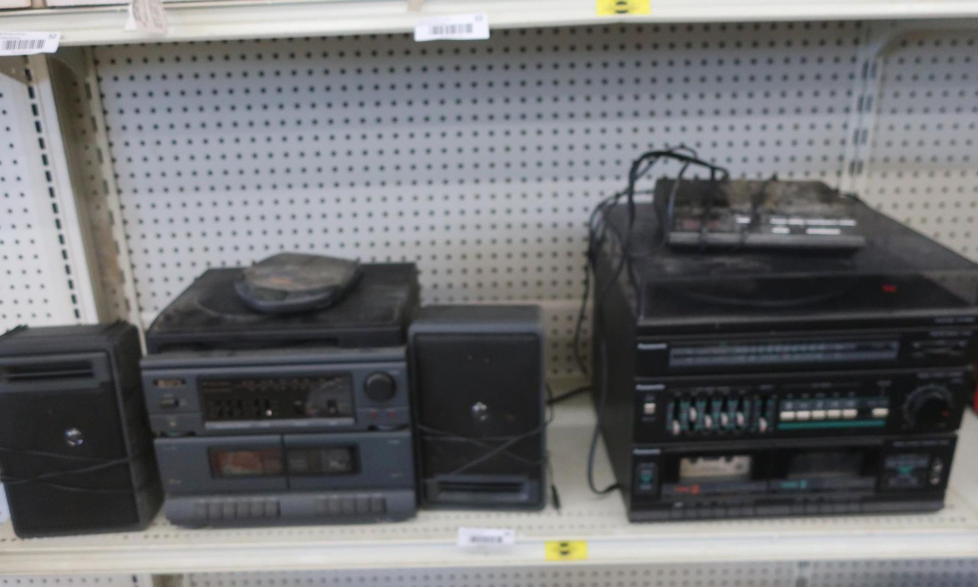 Stereo components on a shelf: two speakers, a CD player, and a larger stereo unit with an equalizer.