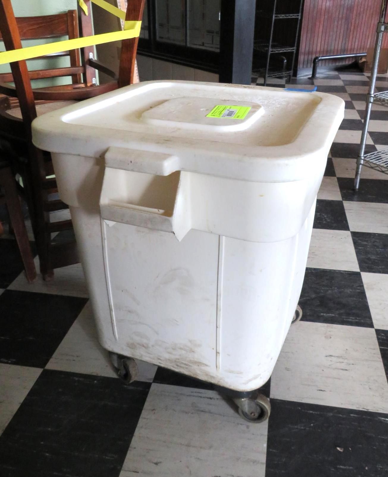 White rolling storage bin on checkered floor.