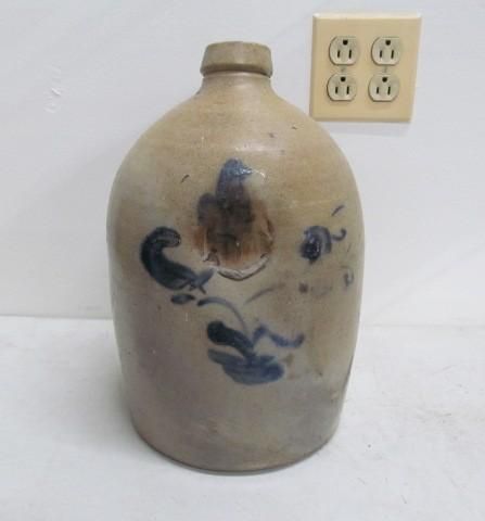 Brown stoneware jug with blue floral decorations.