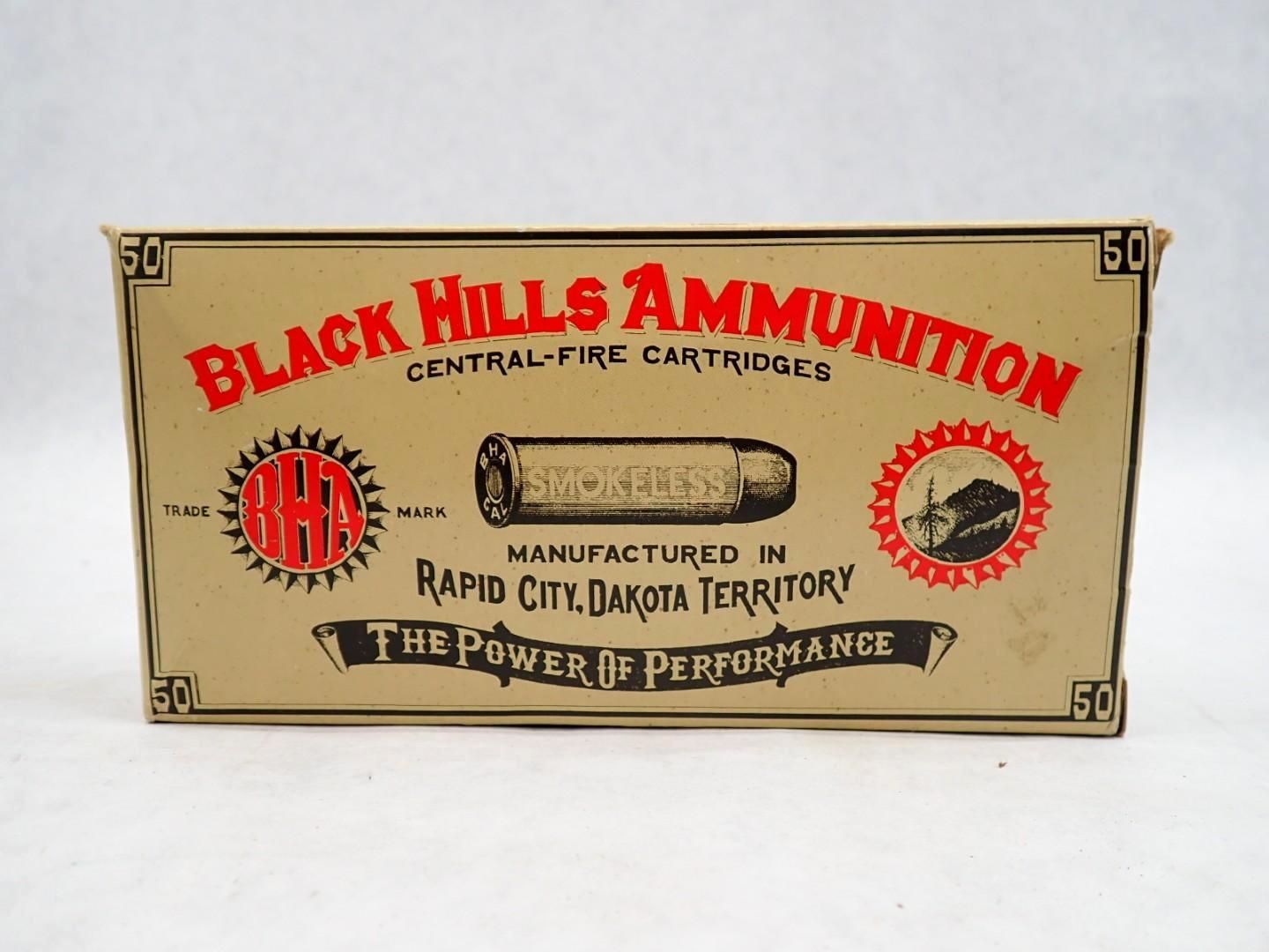 Box of Black Hills Ammunition, tan with red and black text, depicting a cartridge and logos,