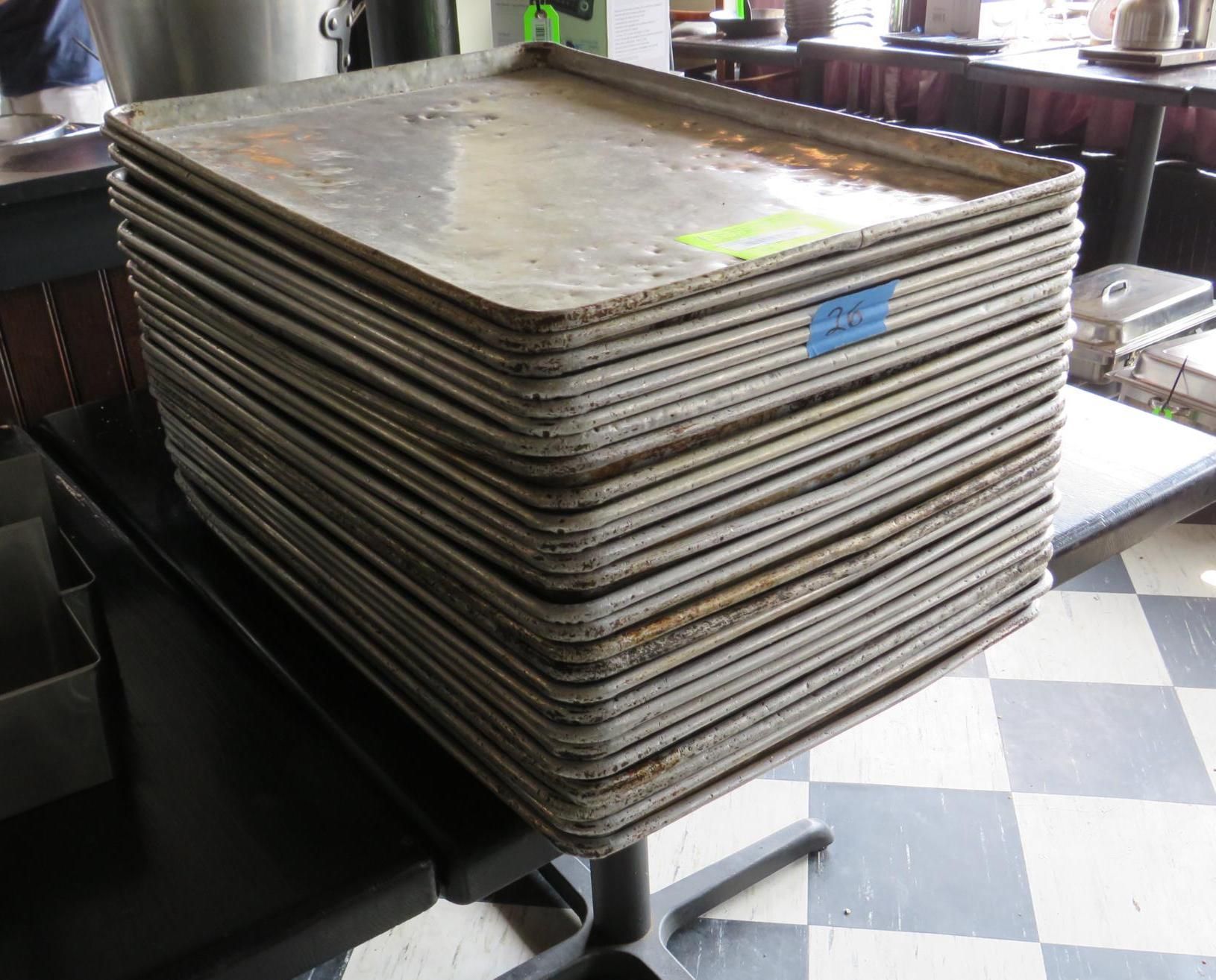 Stack of rectangular, metal baking sheets.