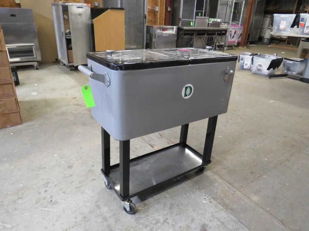 Gray cooler on rolling cart, with black frame and tray, in a warehouse setting.
