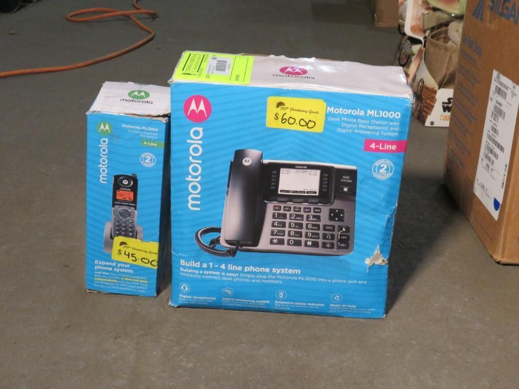 Two Motorola phone boxes on a concrete floor.