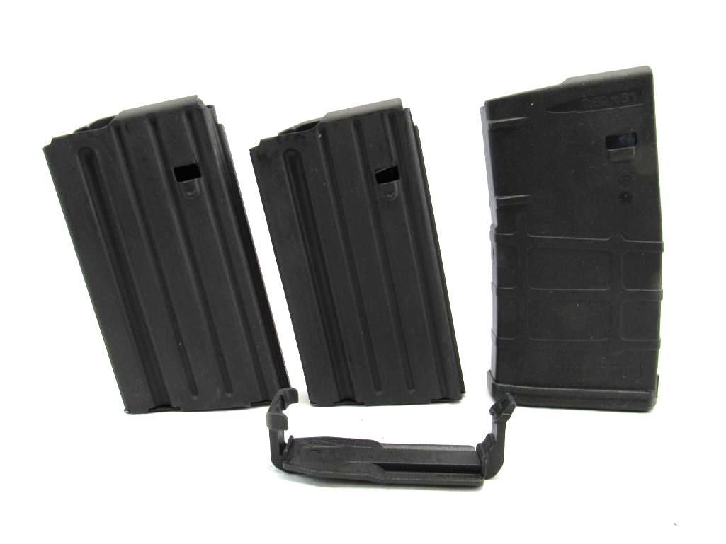 Three black rifle magazines and a connector, angled against a white background.