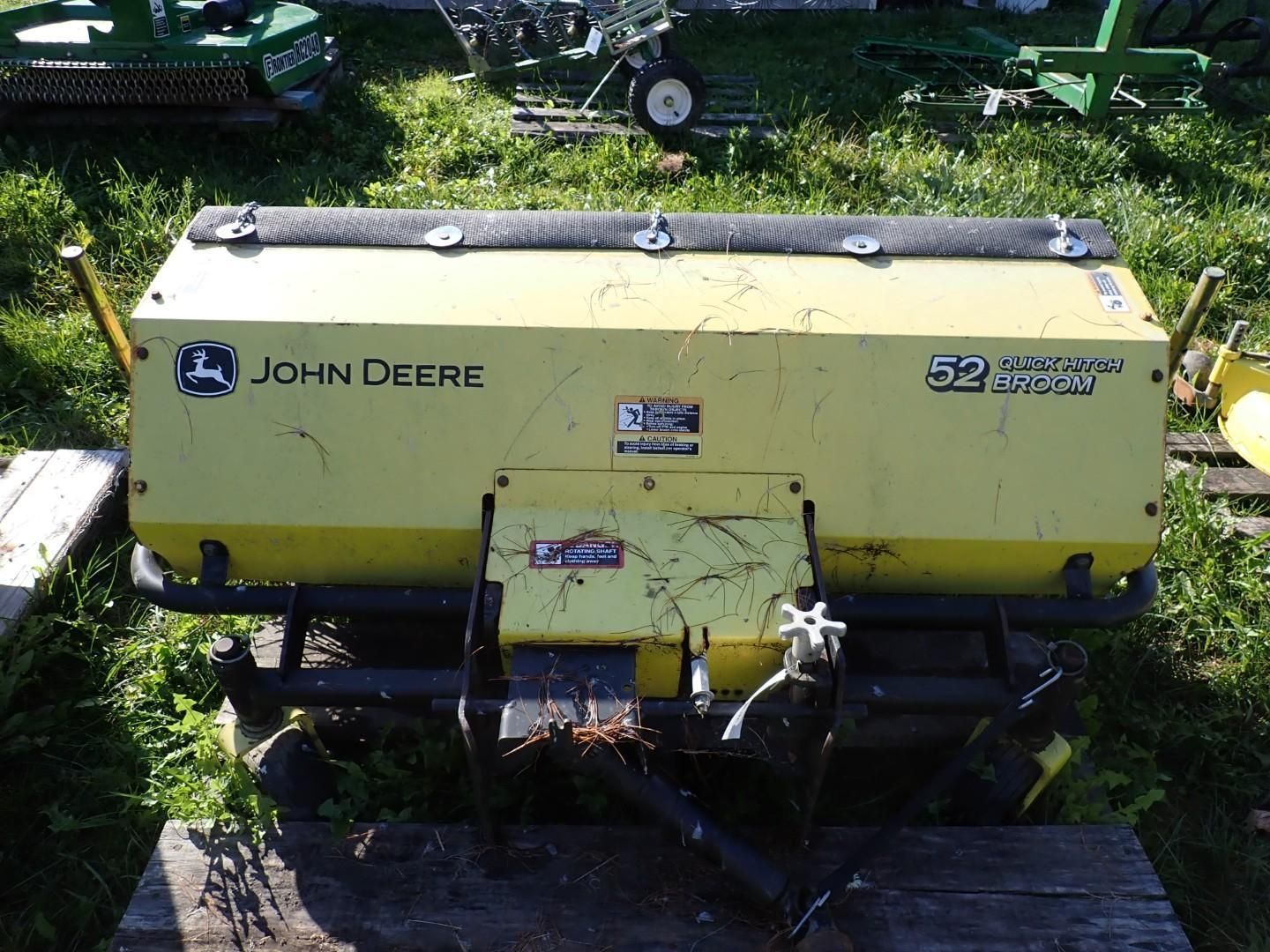 Yellow John Deere farm implement parked on grass, viewed from above