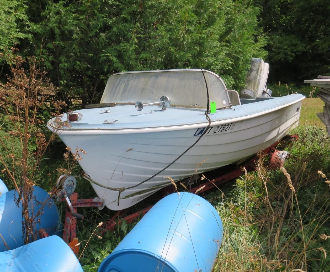 Blue and white motorboat on a red trailer.