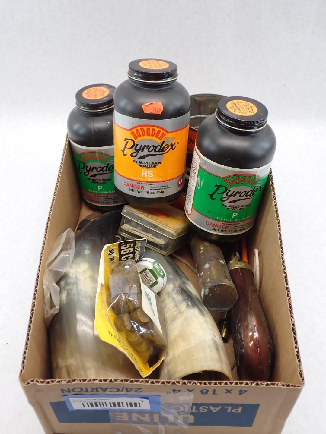 Box of Pyrodex powder containers and related black powder hunting supplies.