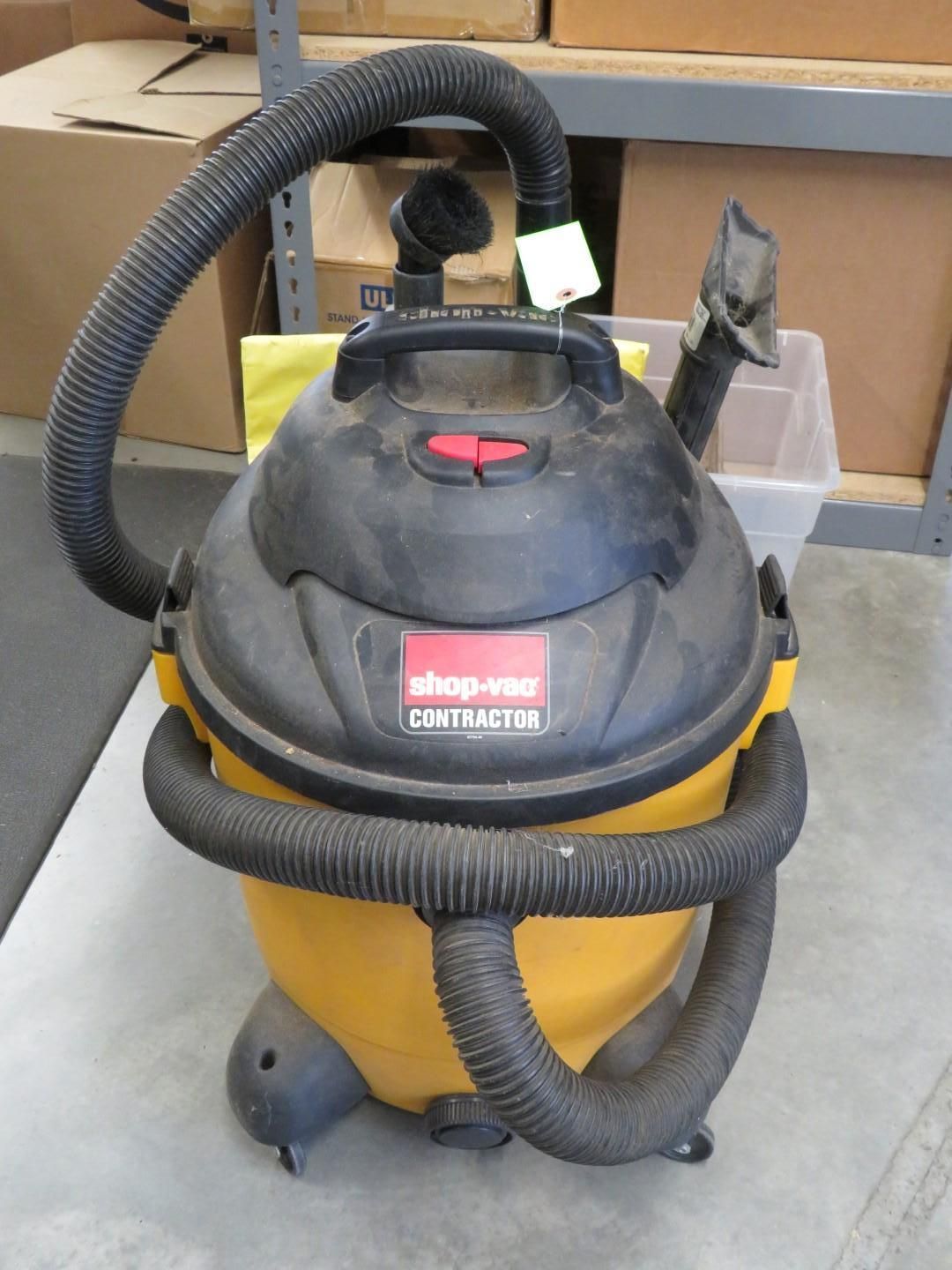 Yellow and black Shop-Vac Contractor vacuum cleaner with hose attachments.