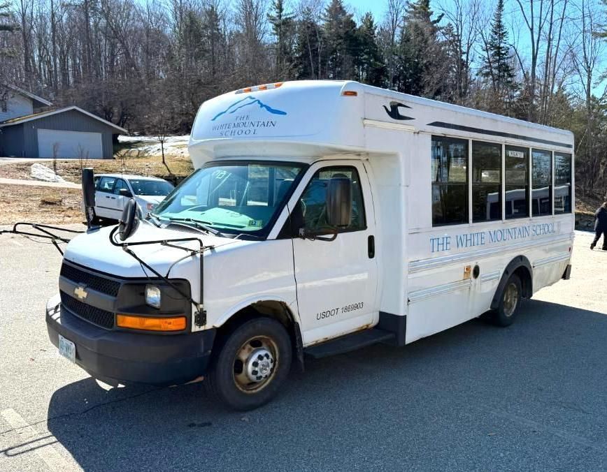 White bus parked outdoors.
