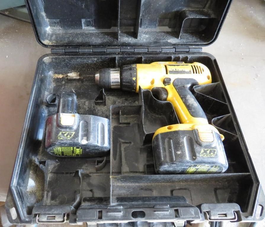 Black and yellow cordless drill and battery in a black case.