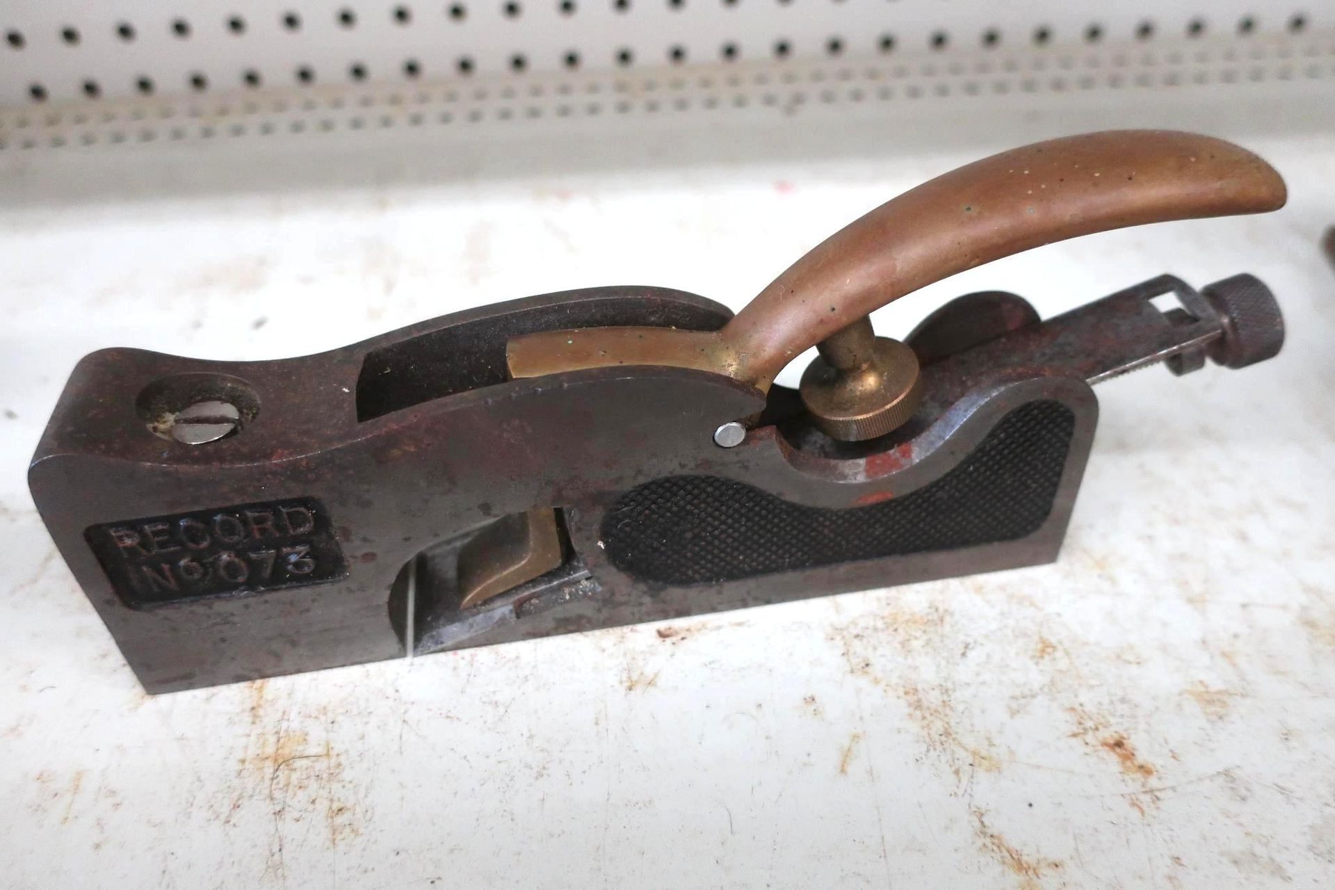 Vintage Record No. 073 shoulder plane. Dark metal with a wooden handle, sitting on a work surface.