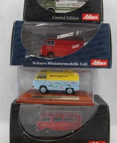 Four Schuco miniature model vans in boxes. Red, yellow/blue, and green color variations.