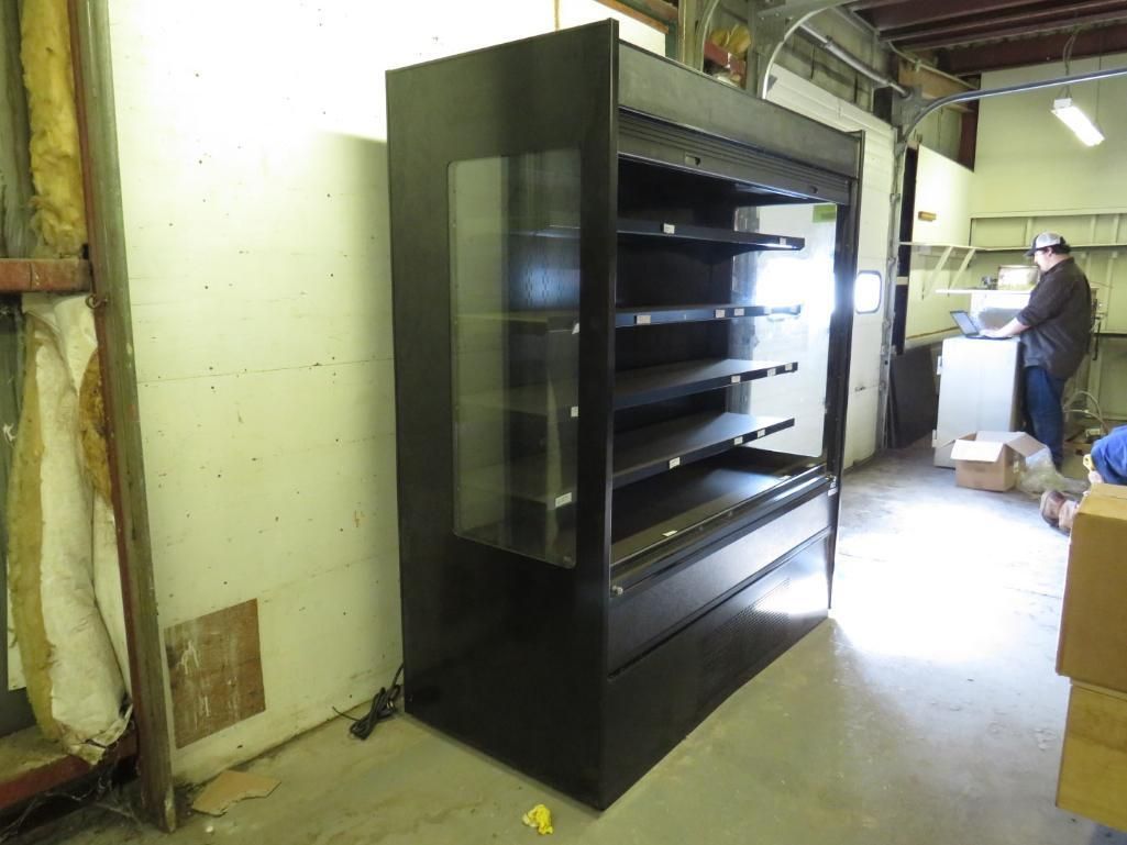 Black commercial display case with glass front in a warehouse.