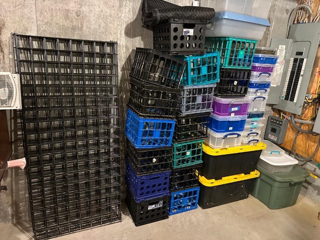 A stack of plastic crates of various colors and a large black wire shelf in a basement.