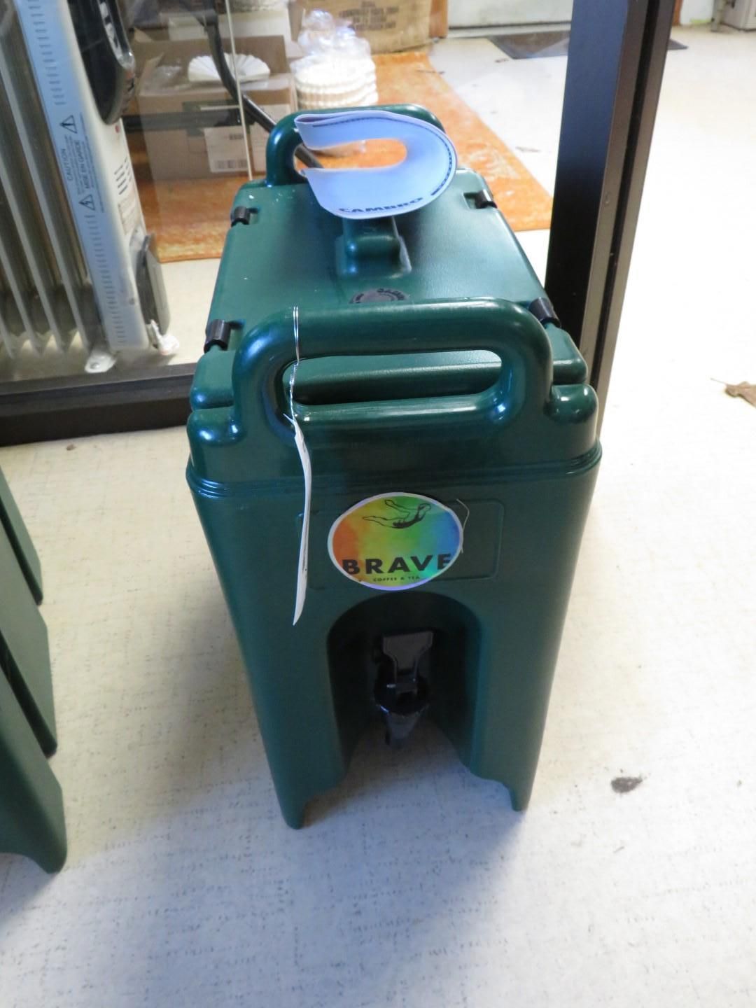 Green plastic water cooler with handle and spigot.