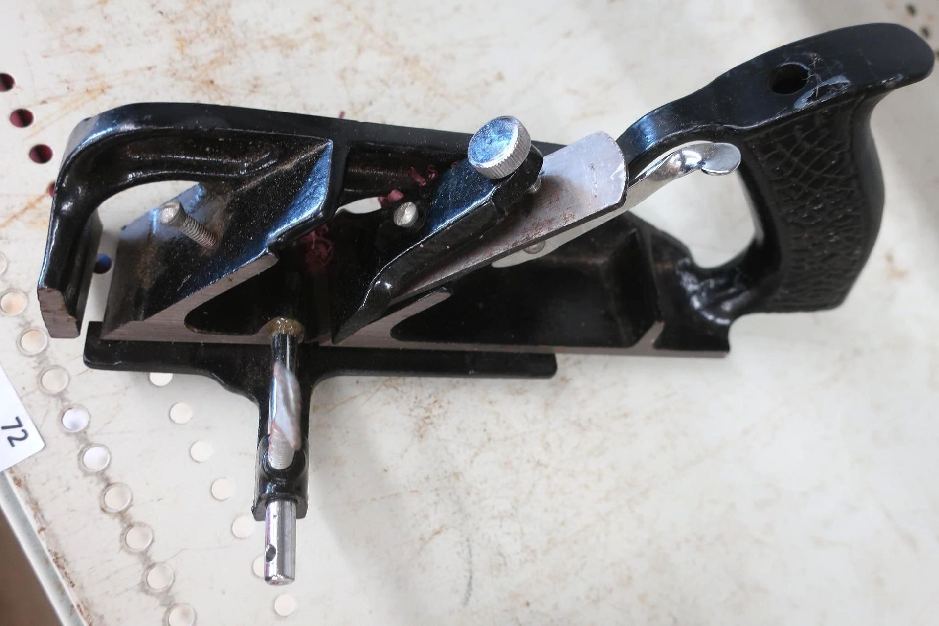 Black adjustable woodworking plane.
