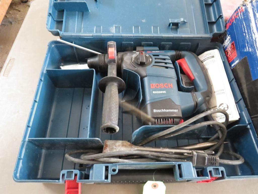 Bosch rotary hammer drill in a blue carrying case.