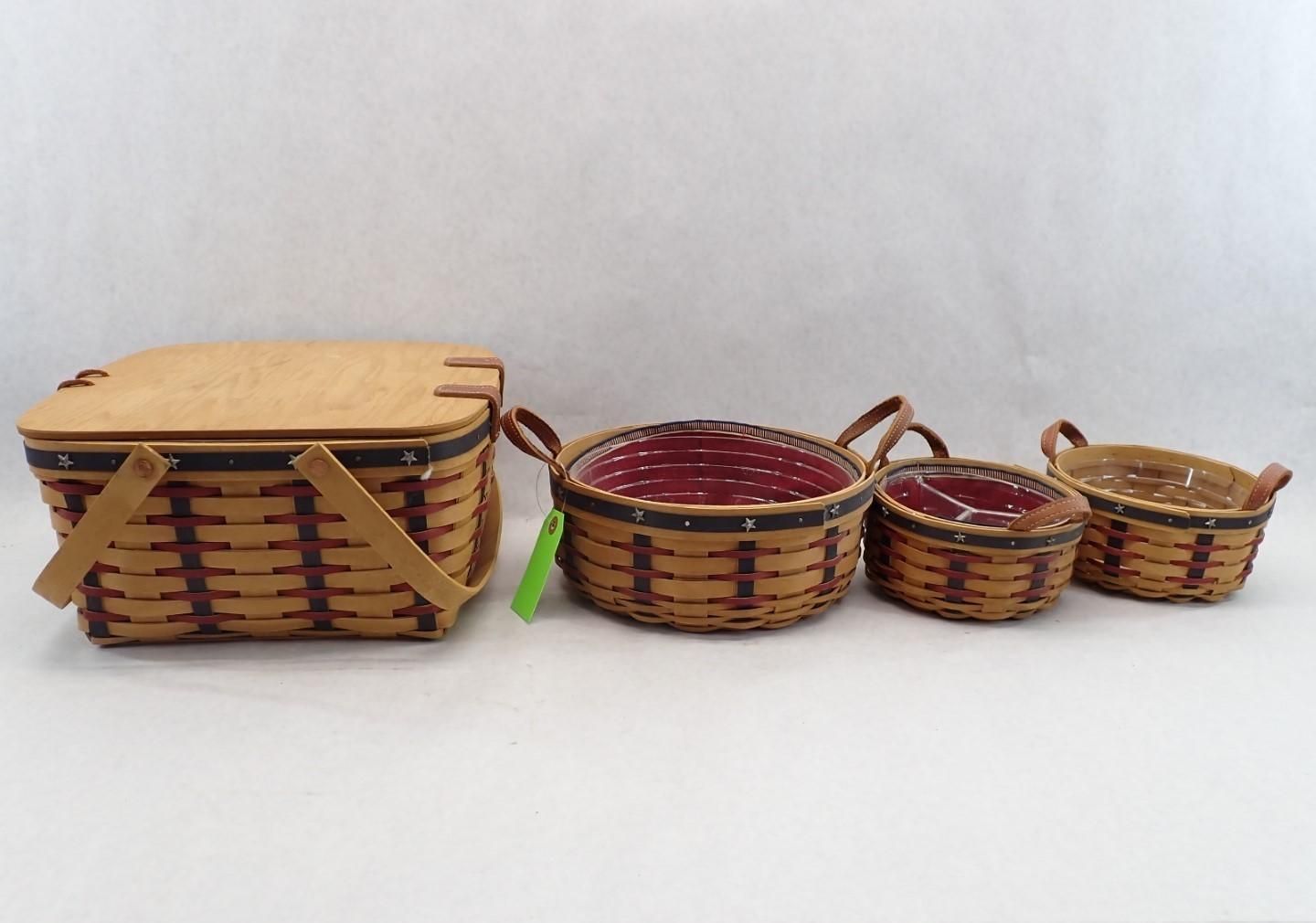 Four woven baskets of varying sizes; one with a lid. Brown and red colors.
