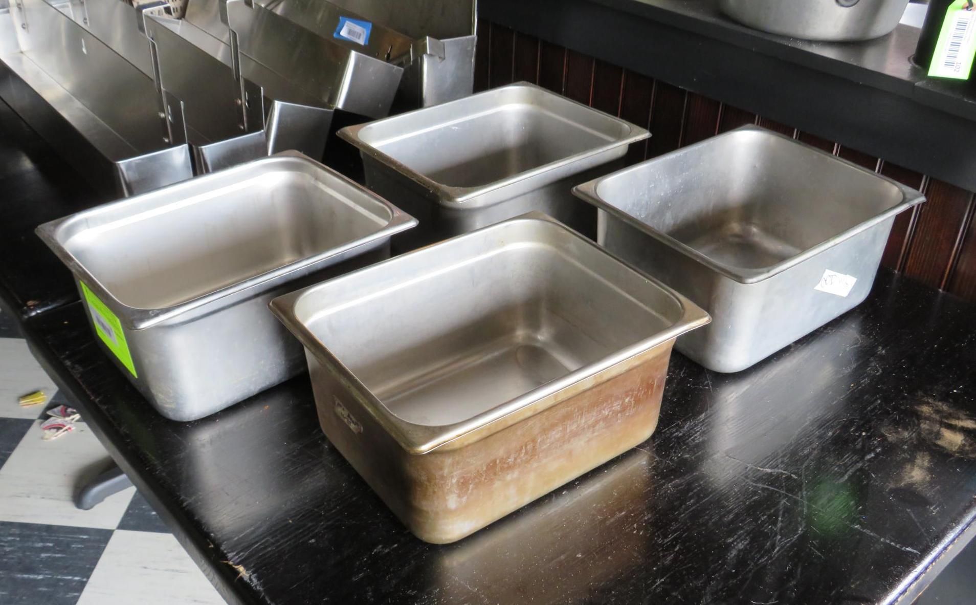 Five stainless steel food pans.