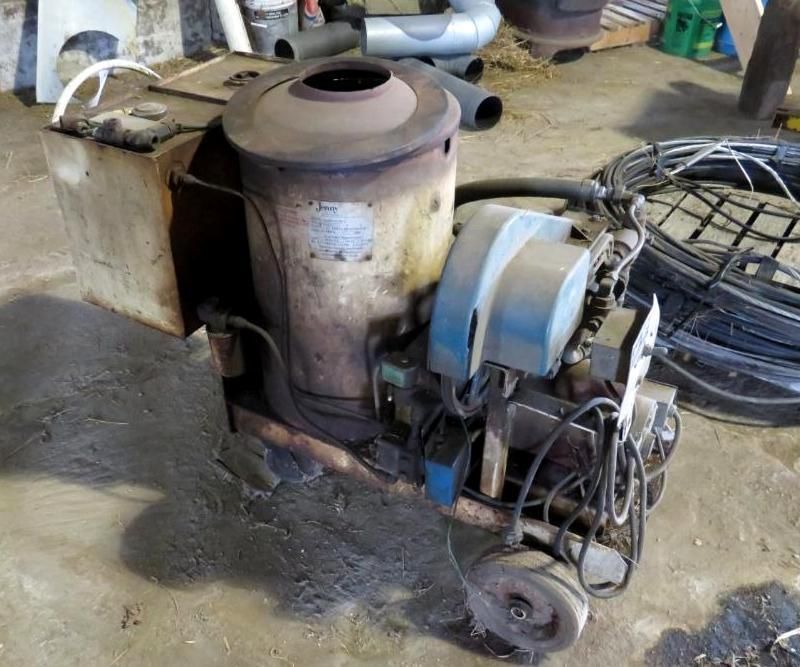 Oil-fired space heater on a concrete floor.