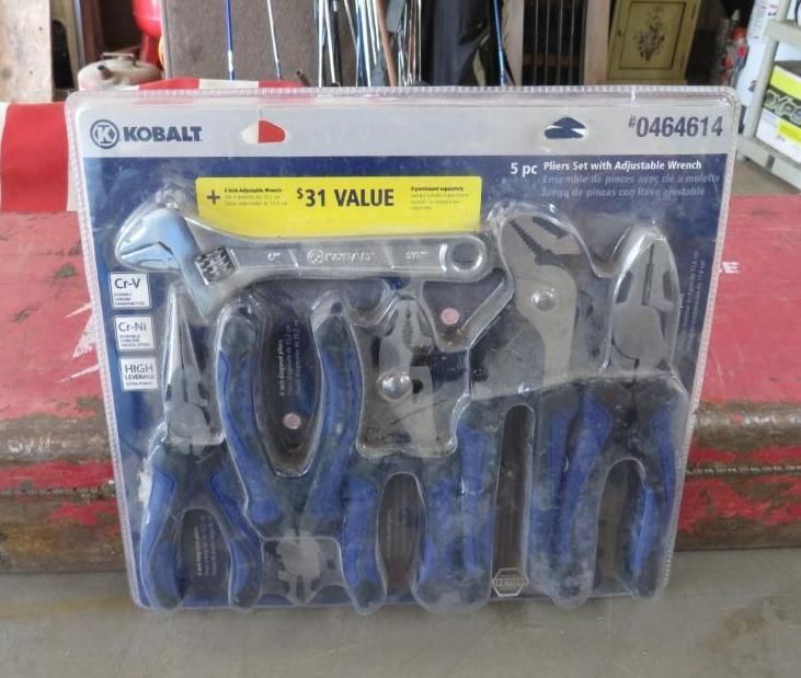 A Kobalt 5-piece tool set, including pliers and an adjustable wrench, in clear packaging on a red surface.