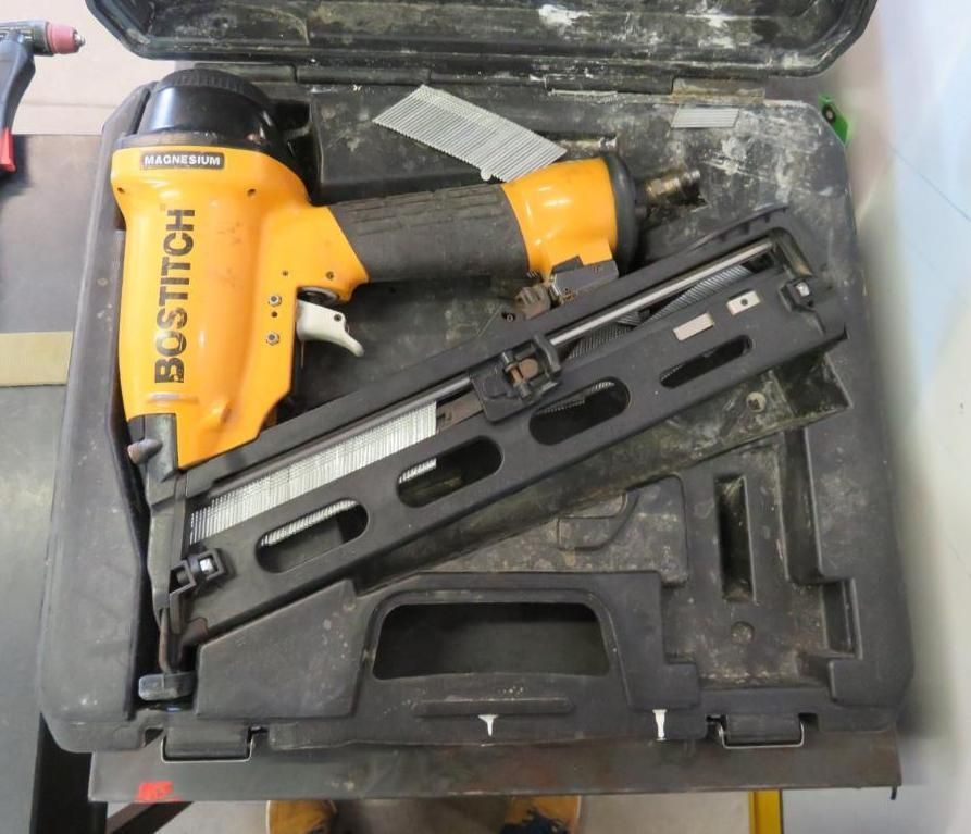 Bostitch pneumatic stapler in a black case; orange and black tool.