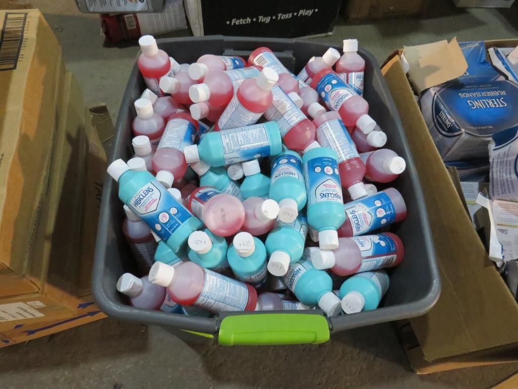 A bin filled with numerous red and blue bottles with white caps.