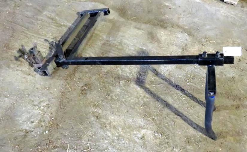 Black metal trailer hitch on a light-colored surface.