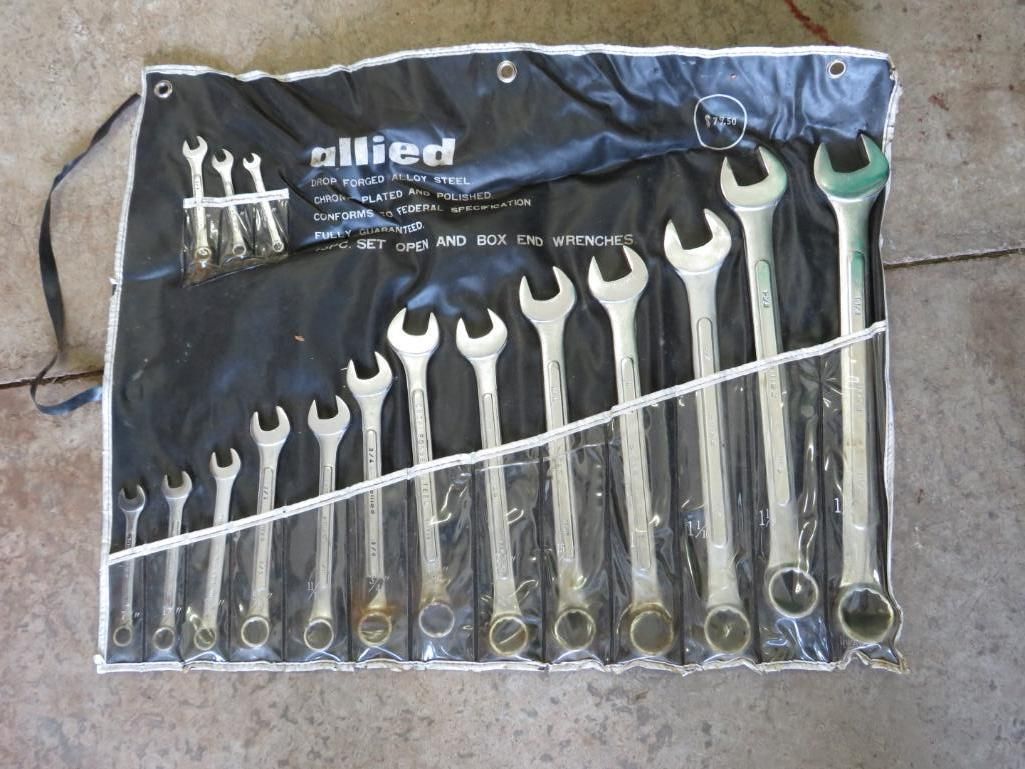 Set of Allied wrenches in a black vinyl roll-up case on a concrete surface.