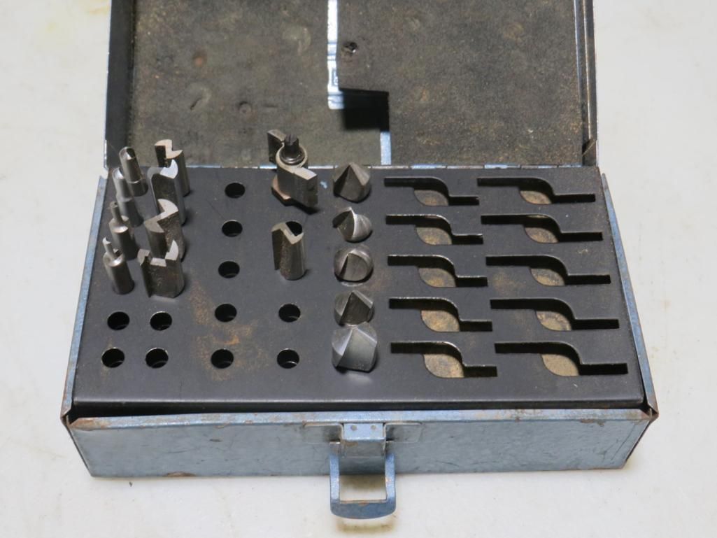 Open metal tool box with drill bits of various sizes.
