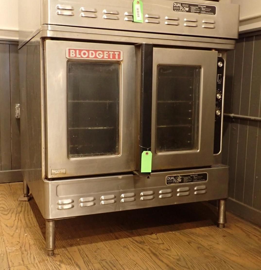 Stainless steel Blodgett commercial oven with two doors, on a wood floor.