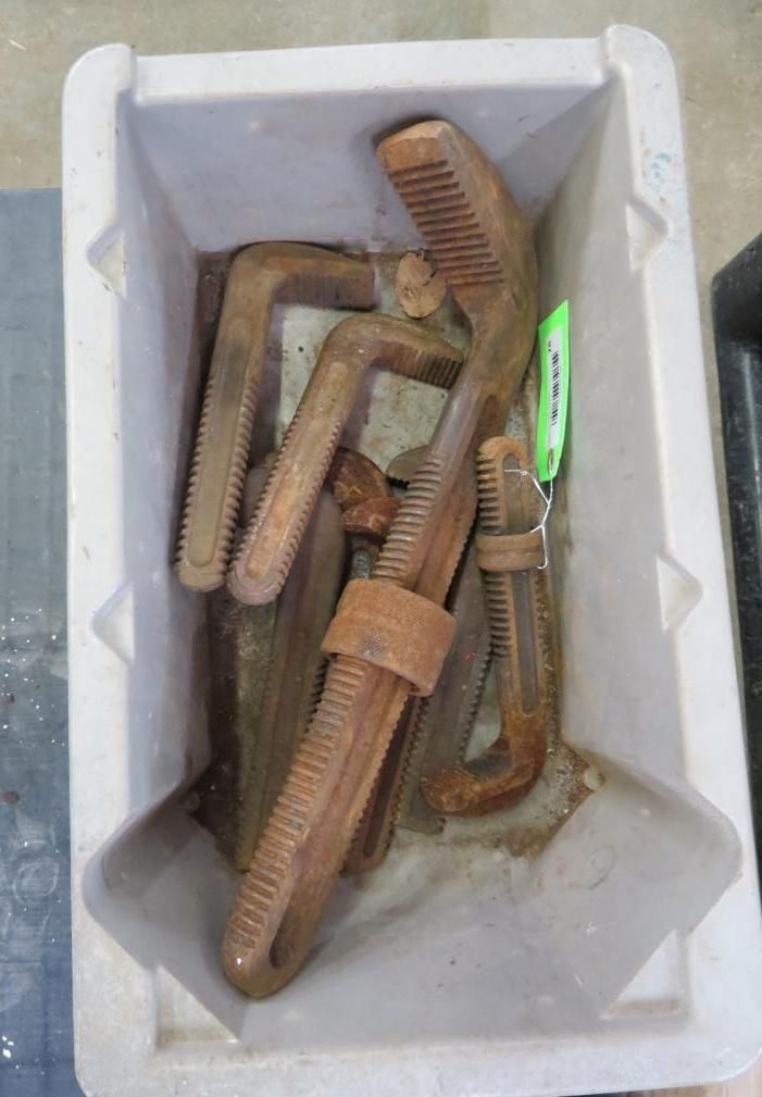 C-clamps in a gray plastic bin.