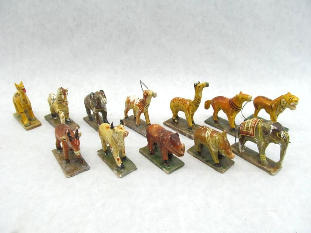 Miniature painted animal figures on rectangular bases, varying colors.