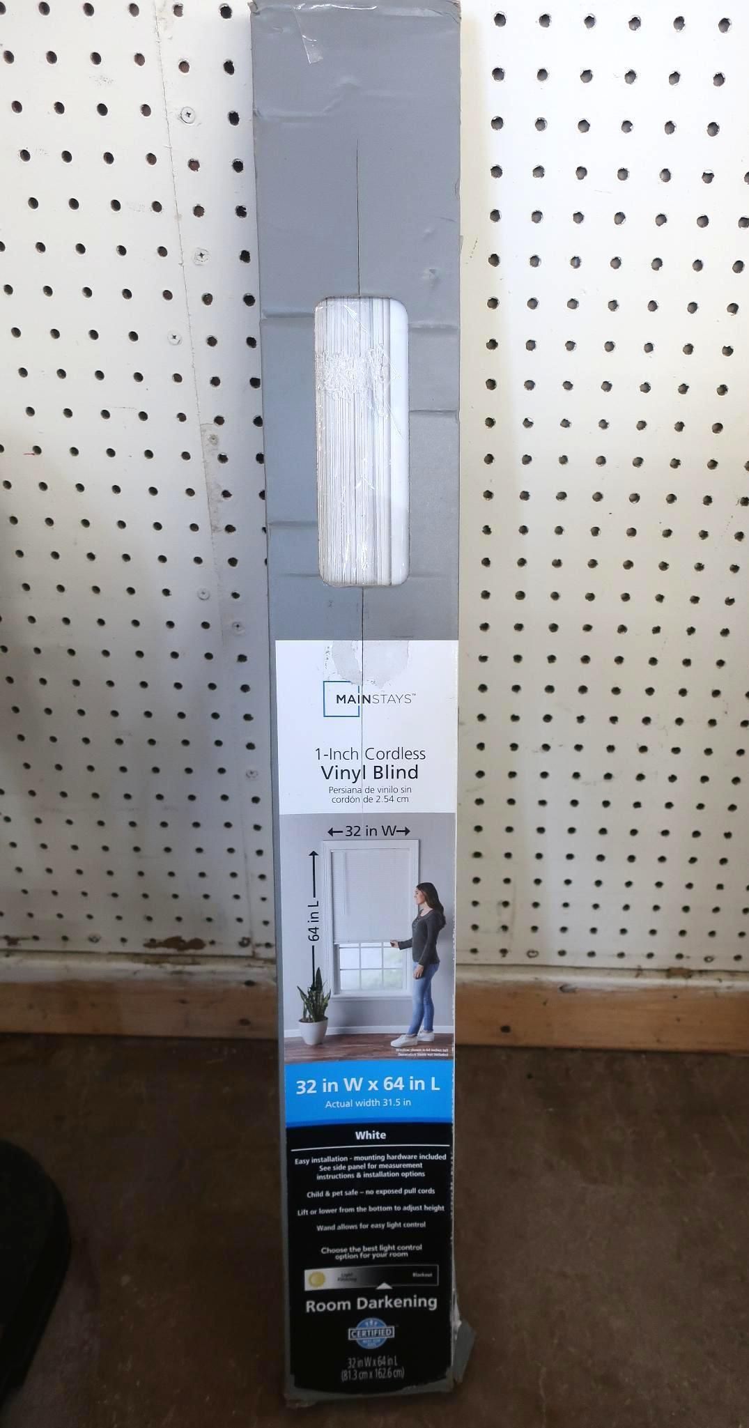 Long, rectangular package on a pegboard background.