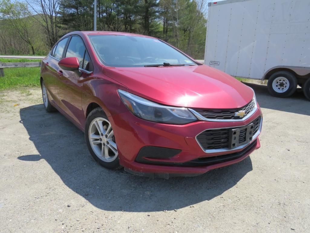 Red Chevrolet Cruze sedan parked outdoors.