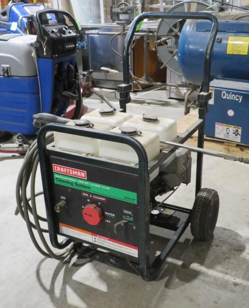 Craftsman pressure washer, black and green control panel, metal frame, two tanks, black hose.