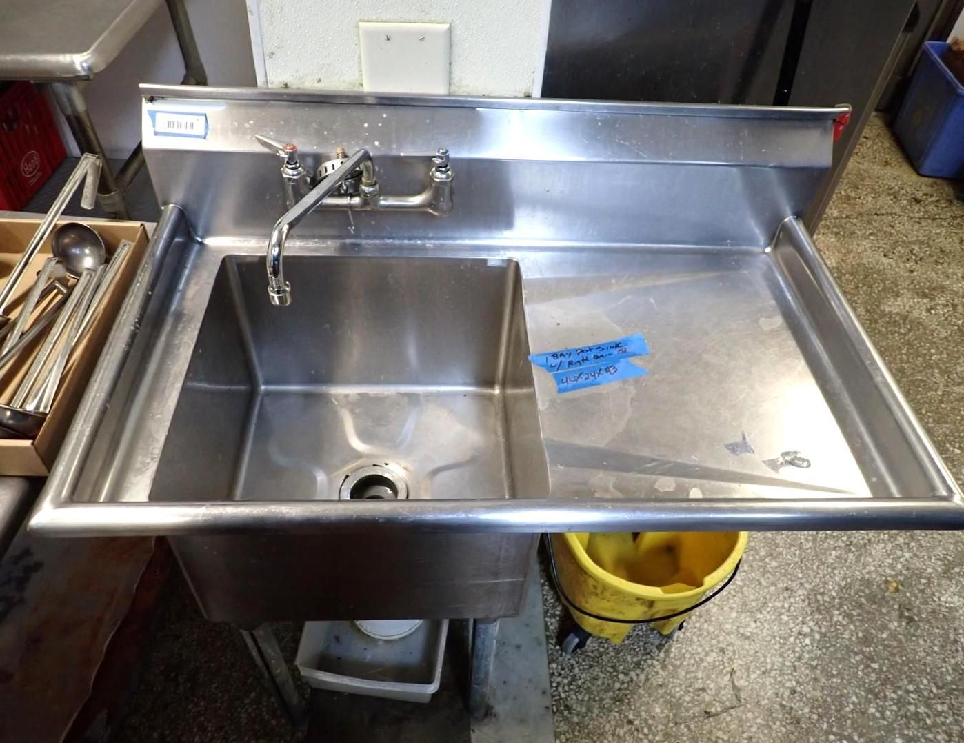 Stainless steel commercial sink with faucet, drainboard.
