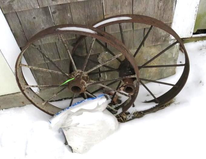 Two antique wagon wheels in snow.