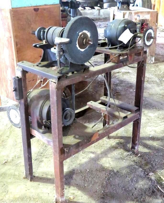 Metal grinder on a stand, featuring a grinding wheel, motor, and pulleys.
